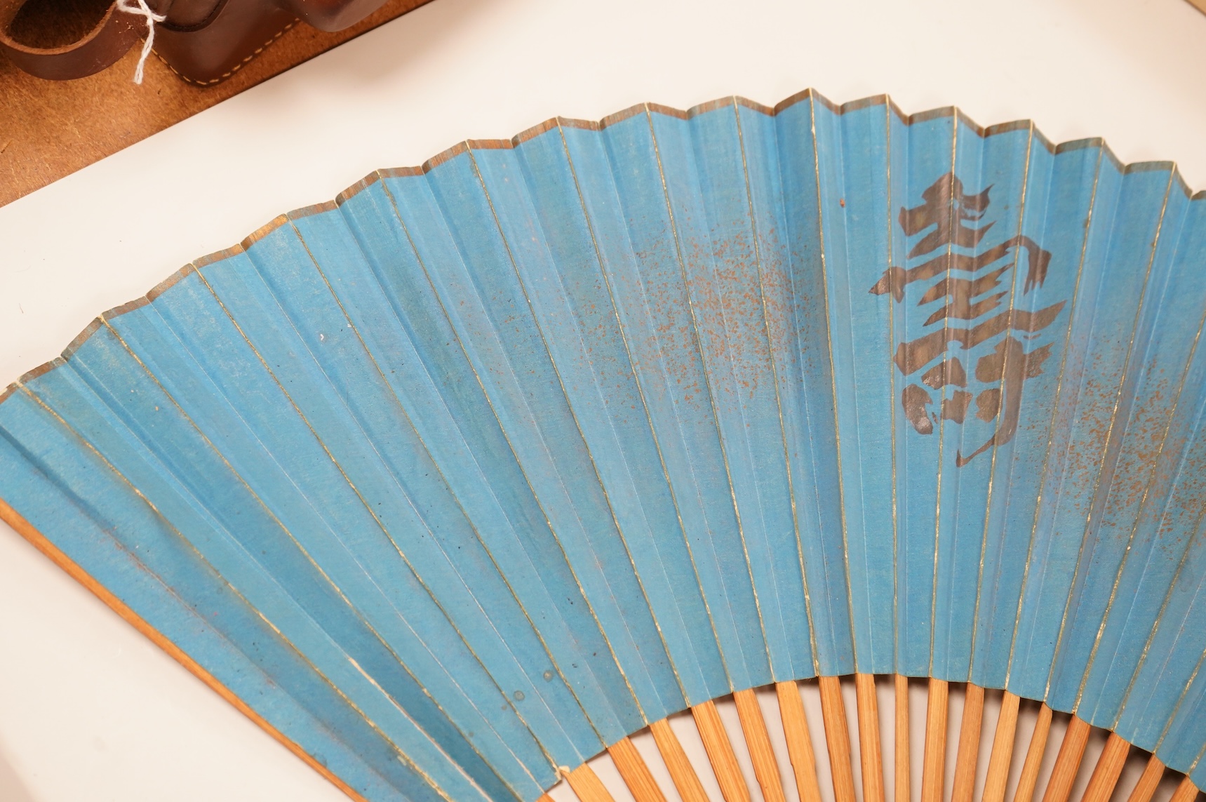 A gold mounted lace and hand painted fan and three others to include a lacquered example, one cased